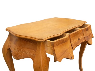 Lot 928 - A continental Pine and beech dressing table.