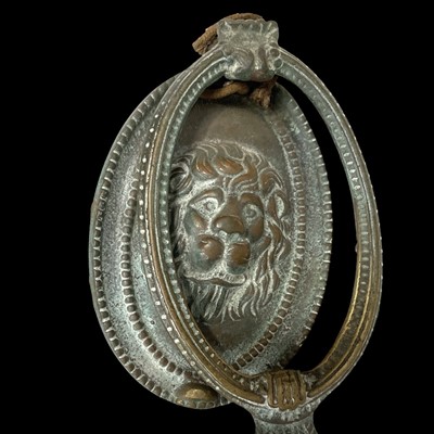 Lot 150 - An antique brass lion's head door knocker,...