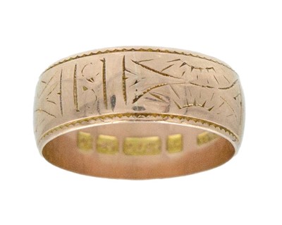 Lot 90 - A 9k rose gold wide band ring with engraved decoration.