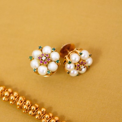 Lot 48 - A pair of high-purity gold, pearl, ruby, diamond, and emerald daisy stud earrings.