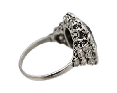 Lot 11 - An Art Deco style black onyx and diamond dress ring set in white gold.