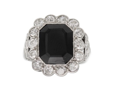 Lot 11 - An Art Deco style black onyx and diamond dress ring set in white gold.