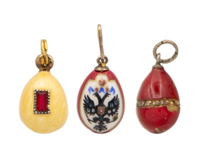 Lot 28 - Three Russian enamel-embellished egg-form pendants.