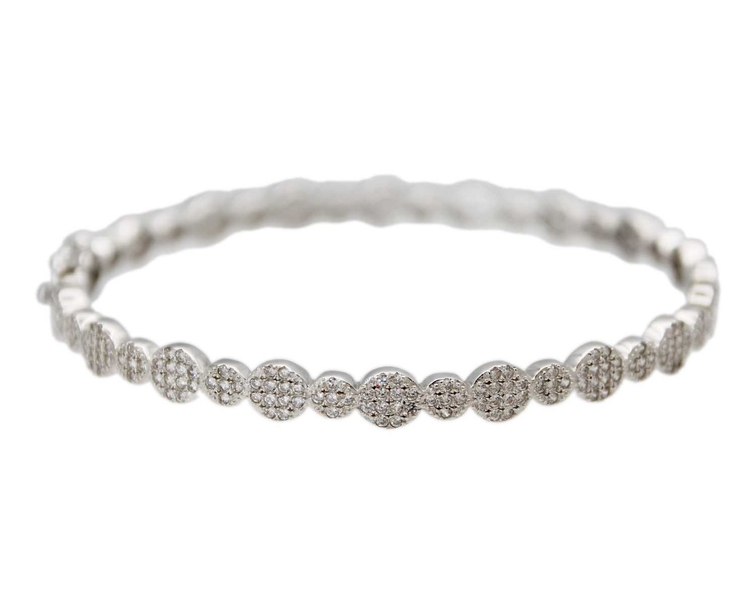 Lot 24 - A silver hinged bangle set with CZ clusters.