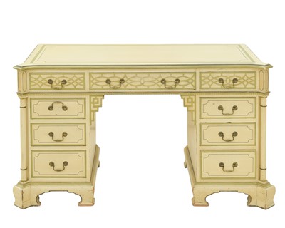 Lot 874 - A cream and green painted pedestal desk.