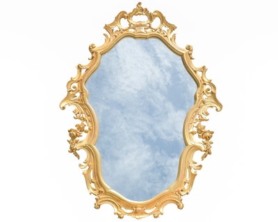 Lot 813 - A carved giltwood rococo style wall mirror.