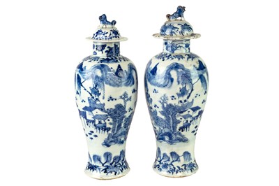 Lot 392 - A pair of Chinese blue and white baluster vases and covers.