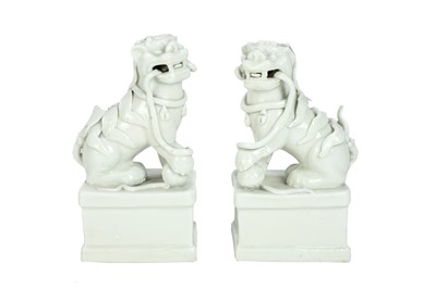 Lot 406 - A pair of Chinese blanc de chine Buddhistic lions.