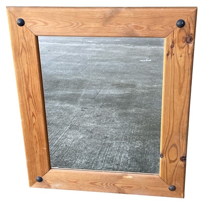 Lot 121 - A Pine wall mirror with iron stud detail to...