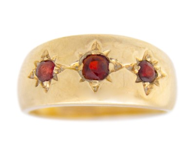Lot 131 - A 9k garnet set three-stone Gypsy ring.