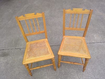 Lot 14 - A Pair of Oak Chairs with Cane Seating. The...