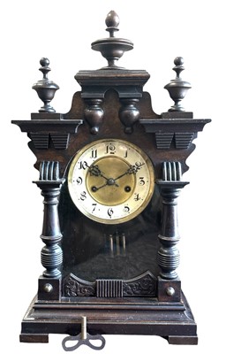 Lot 149 - An oak eight-day gingerbread two train mantel...