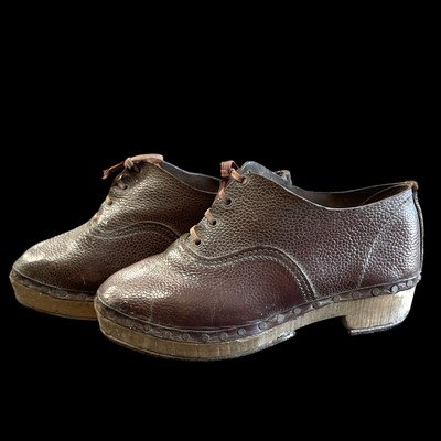 Lot 173 - A pair of vintage leather and wooden clogs,...