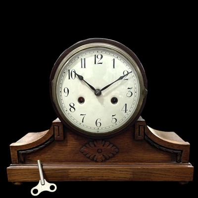 Lot 64 - An oak chiming mantel clock, 27cm in height.