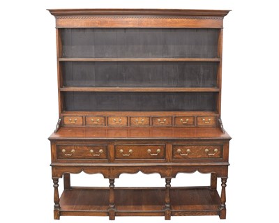 Lot 872 - A George III style oak dresser.