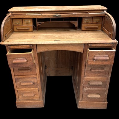 Lot 10 - An Oak Roll Top Desk. The Desk is 103cm tall,...