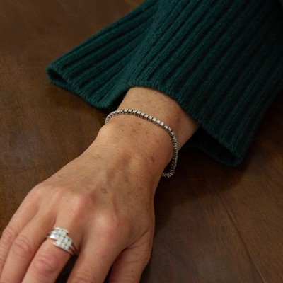 Lot 214 - A good 18k white gold diamond set line bracelet.