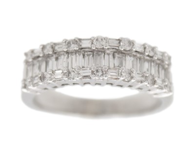 Lot 96 - A 14k white gold and diamond band ring.