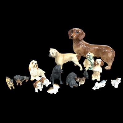 Lot 48 - A collection of dog figures in a variety of...