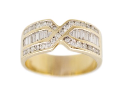 Lot 118 - A 14k gold and diamond band ring.
