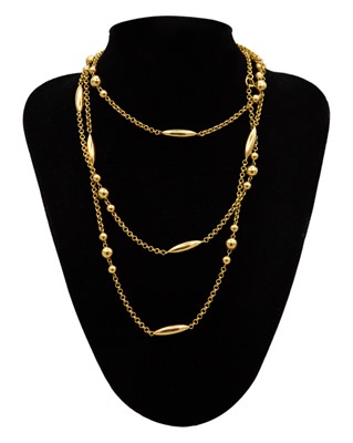 Lot 125 - An 18k gold spaced bead on a curb chain 56" long neck chain.