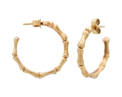 Lot 127 - A pair of 9k gold bamboo design hoop earrings.