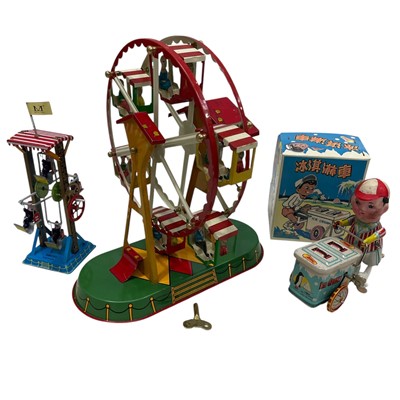 Lot 107 - A Vintage tin wind-up Ferris wheel (22cm high)...