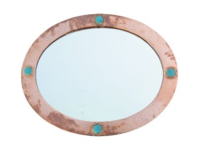 Lot 855 - An arts and crafts hammered copper mirror.