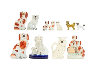 Lot 591 - A 19th century Staffordshire flatback, two spaniel dogs with a barrel.