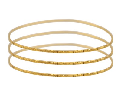 Lot 176 - A set of three high-purity gold bangles.