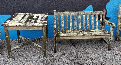 Lot 771 - A weathered, lichen covered, teak garden bench.