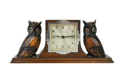 Lot 804 - An Art Deco carved oak mantel clock.