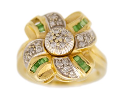 Lot 213 - A 14k gold diamond and peridot dress ring.