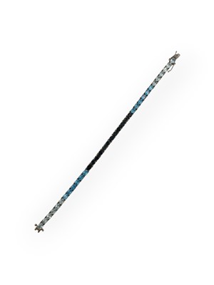 Lot 47 - A silver line bracelet set with mixed blue colour topaz.
