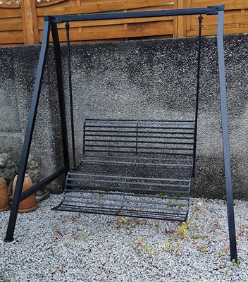 Lot 749A - A large black painted wrought metal garden swing bench.
