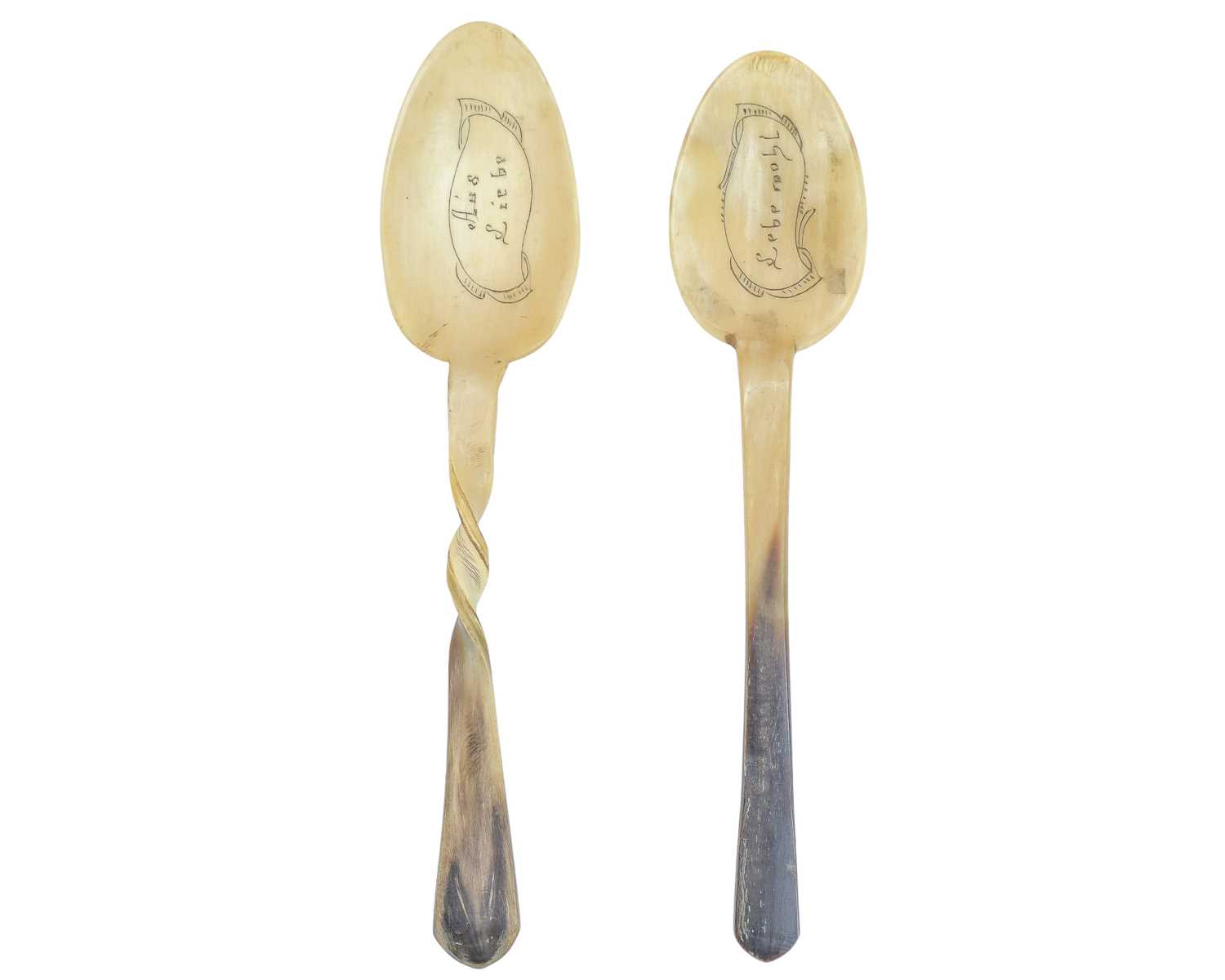 Lot 76 - Two German horn love spoons.