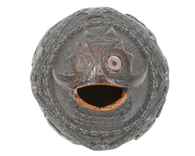Lot 750 - A carved coconut bugbear money box.