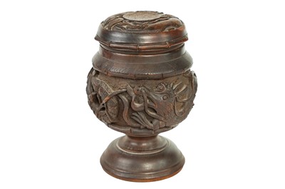 Lot 405 - An Eastern carved wood and metal lined tobacco jar and cover.
