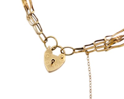 Lot 169 - A 9k gold gate link bracelet with a padlock clasp.