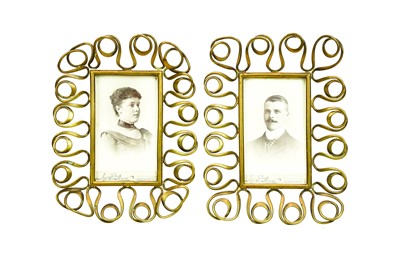 Lot 97 - A pair of Arts and Crafts brass photo frames.
