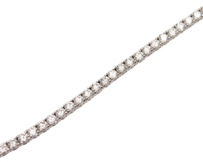 Lot 174 - A 14k white gold diamond line bracelet.
