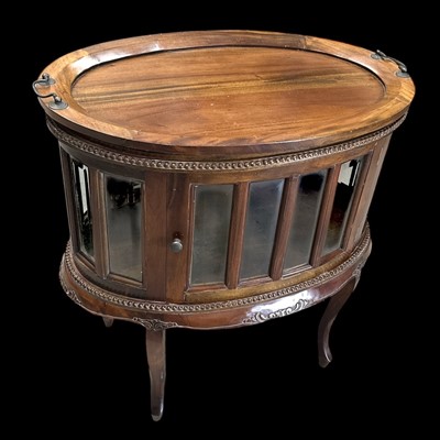 Lot 16 - An oval mahogany drinks cabinet with a...