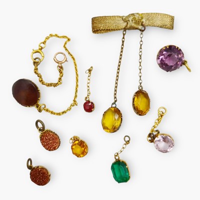 Lot 14 - A selection of nine paste set charms in yellow metal.