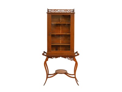 Lot 947 - An Edwardian walnut display cabinet on stand.