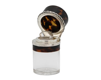 Lot 182 - An unusual Edwardian silver and tortoiseshell pique ware hinge lidded glass scent bottle.