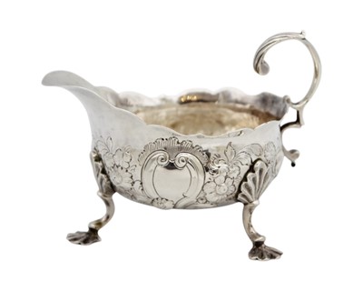 Lot 115 - A George II silver sauce boat with foliate embossed decoration.