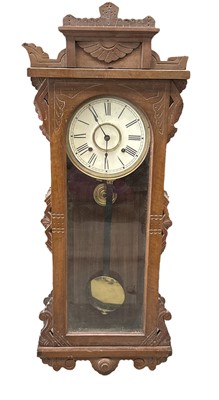 Lot 192 - A carved wooden wall clock, height 96cm.