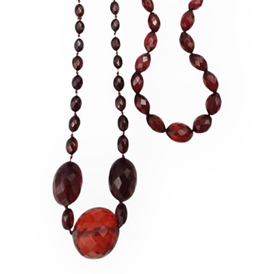 Lot 28 - Two cherry amber-style faceted necklaces.