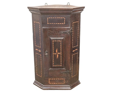 Lot 877 - A 19th century oak and chevron strung corner hanging cupboard.