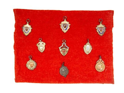 Lot 276 - Four enamelled silver Cornwall County FA fobs.